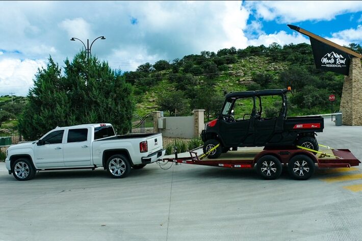 golf cart on red flat bed arrow trail trailer