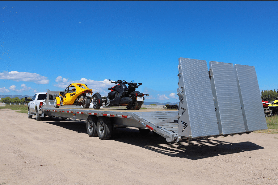 two ATVS on the back of a silver arrow trail trailer